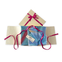 Set of scarves in a gift box with a pink ribbon on a white background. 
Hand-painted silk cotton blend scarf by Otta-Italy, 70 x 190 cm, featuring 
blue, yellow, red, orange and green shades. Luxury Italian pure silk accessory, soft, fresh and lightweight scarf for women and men.
