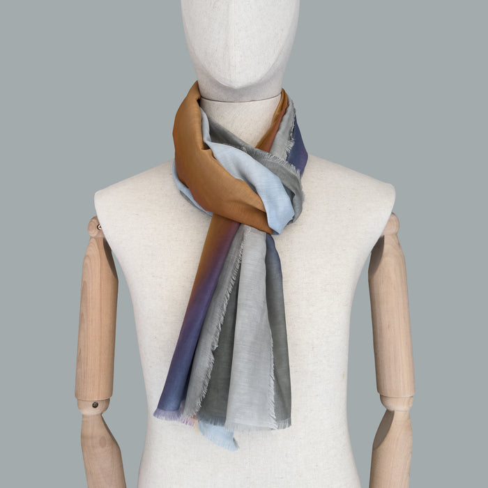 Mannequin wearing scarf on a gray background. Hand-painted silk cotton scarf by Otta-Italy, measuring 70 x 190 cm, featuring 
gray, purple and orange shades. Luxury Italian pure silk cotton blend accessory, soft, fresh and lightweight scarf for women and men.
