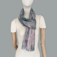 Mannequin wearing scarf on a gray background. Hand-painted silk cotton scarf by Otta-Italy, measuring 70 x 190 cm, featuring 
pink and green shades. Luxury Italian pure silk cotton blend accessory, soft, fresh and lightweight scarf for women and men.

