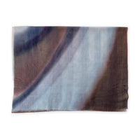 Pure cashmere hand-painted scarf by Otta-Italy flat lay on a white background. Elegant light blue, beige, brown and gray shades. 67x195 cm.

