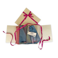 Set of scarves in a gift box with a pink ribbon on a white background. Hand-painted pure cashmere scarf by Otta-Italy, 65 x 194 cm, featuring aquamarine, pink, coral, green and grey colors. Luxury Italian cashmere accessory, soft and warm scarf for women and men
