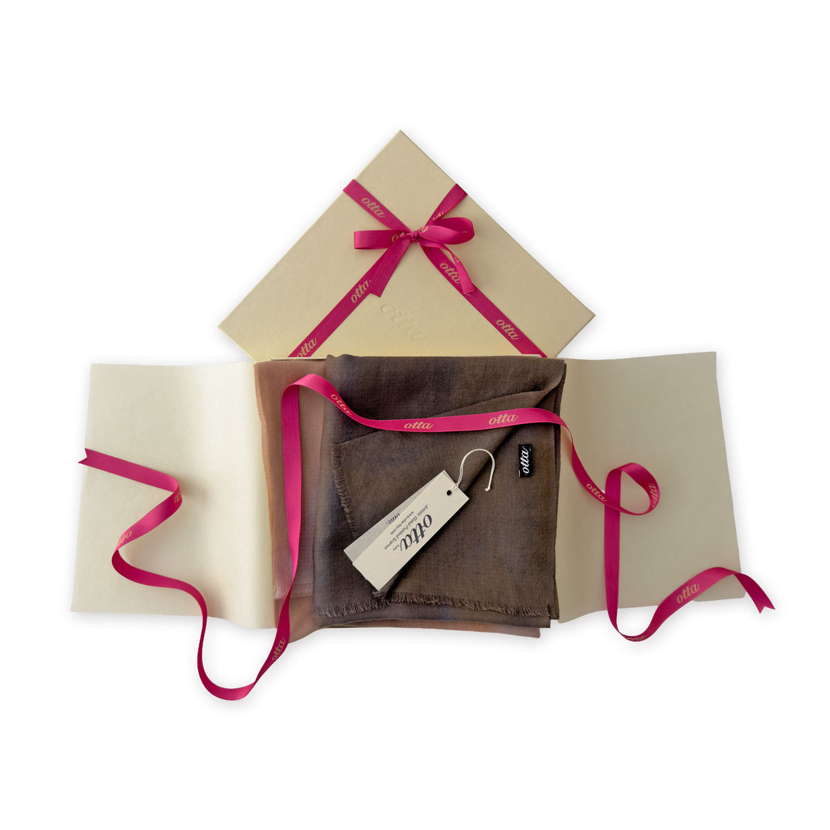 Luxury gift box with a pink ribbon containing a hand-painted Otta pure cashmere scarf on a white background.
