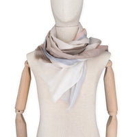 Mannequin wearing scarf on a white background. Hand-painted pure cashmere scarf by Otta-Italy, 66 x 200 cm, featuring light gray, beige, pink and brown. Luxury Italian cashmere accessory, soft and warm scarf for women and men.
