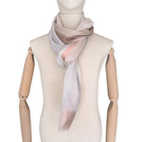 Mannequin wearing scarf on a white background. Hand-painted pure cashmere scarf by Otta-Italy, 66 x 200 cm, featuring light gray, beige, pink and brown. Luxury Italian cashmere accessory, soft and warm scarf for women and men.
