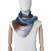 Mannequin wearing scarf on a white background. Hand-painted pure cashmere scarf by Otta-Italy, 67 x 200 cm, featuring dark gray, blue and brown. Luxury Italian cashmere accessory, soft and warm scarf for women and men.
