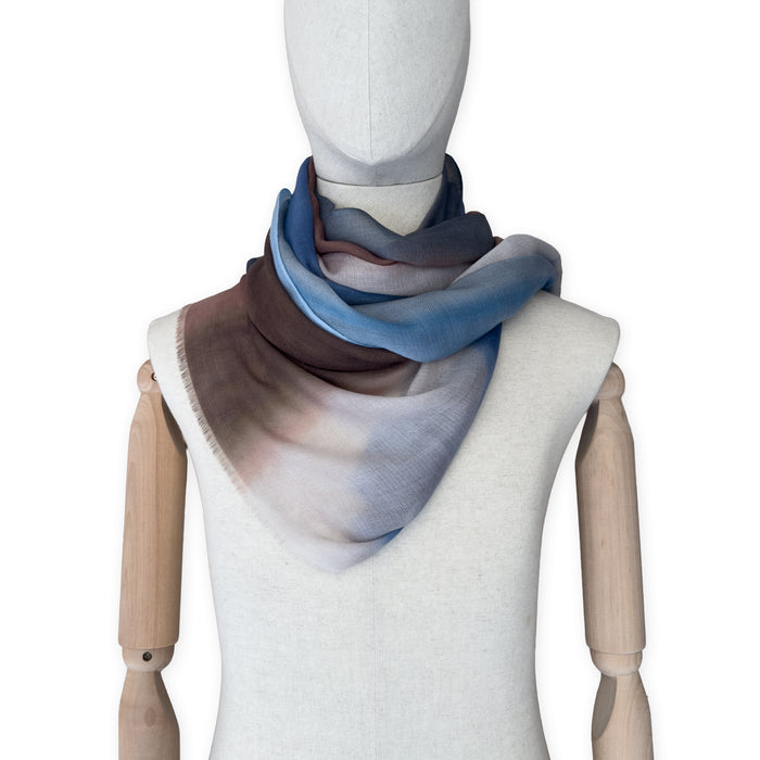 Mannequin wearing scarf on a white background. Hand-painted pure cashmere scarf by Otta-Italy, 67 x 200 cm, featuring dark gray, blue and brown. Luxury Italian cashmere accessory, soft and warm scarf for women and men.
