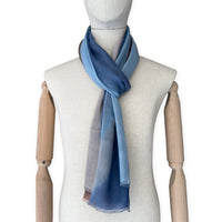 Mannequin wearing scarf on a white background. Hand-painted pure cashmere scarf by Otta-Italy, 67 x 200 cm, featuring dark gray, blue and brown. Luxury Italian cashmere accessory, soft and warm scarf for women and men.
