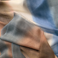 Close-up of soft fabric. Hand-painted pure cashmere scarf by Otta-Italy, 67 x 200 cm, featuring dark gray and brown. Luxury Italian cashmere accessory, soft and warm scarf for women and men.
