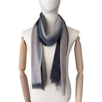 Mannequin wearing scarf on a white background. Hand-painted pure cashmere scarf by Otta-Italy, 67 x 200 cm, featuring dark gray and brown. Luxury Italian cashmere accessory, soft and warm scarf for women and men.
