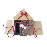 Set of scarves in a gift box with a pink ribbon on a white background. 
Hand-painted pure cashmere scarf by Otta-Italy, 67 x 200 cm, featuring dark gray and brown. Luxury Italian cashmere accessory, soft and warm scarf for women and men.
