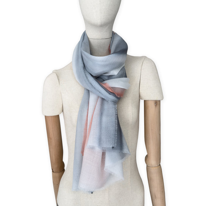 Mannequin wearing scarf on a white background. Hand-painted pure cashmere scarf by Otta-Italy, 66 x 198 cm, featuring grey and coral. Luxury Italian cashmere accessory, soft and warm scarf for women and men.

