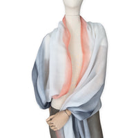 Mannequin wearing scarf on a white background. Hand-painted pure cashmere scarf by Otta-Italy, 66 x 198 cm, featuring grey and coral. Luxury Italian cashmere accessory, soft and warm scarf for women and men.
