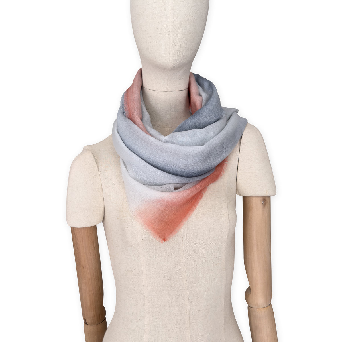 Mannequin wearing scarf on a white background. Hand-painted pure cashmere scarf by Otta-Italy, 66 x 198 cm, featuring grey and coral. Luxury Italian cashmere accessory, soft and warm scarf for women and men.
