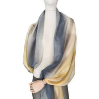 Mannequin wearing scarf on a white background. Hand-painted pure cashmere scarf by Otta-Italy, 66 x 198 cm, featuring ochre, yellow and grey. Luxury Italian cashmere accessory, soft and warm scarf for women and men.
