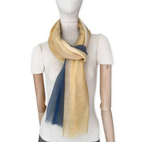 Mannequin wearing scarf on a white background. Hand-painted pure cashmere scarf by Otta-Italy, 66 x 198 cm, featuring ochre, yellow and grey. Luxury Italian cashmere accessory, soft and warm scarf for women and men.
