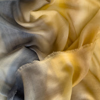Close-up of soft fabric. Hand-painted pure cashmere scarf by Otta-Italy, 66 x 198 cm, featuring ochre, yellow and grey. Luxury Italian cashmere accessory, soft and warm scarf for women and men.
