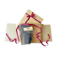 
Set of scarves in a gift box with a pink ribbon on a white background. 
Hand-painted pure cashmere scarf by Otta-Italy, 66 x 198 cm, featuring ochre, yellow and grey. Luxury Italian cashmere accessory, soft and warm scarf for women and men.
