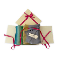 Set of scarves in a gift box with a pink ribbon on a white background. 
Hand-painted cashmere scarf by Otta-Italy, 68 x 202 cm, featuring 
green, yellow, gray and brown. Luxury Italian pure cashmere accessory, soft and warm scarf for women and men.
