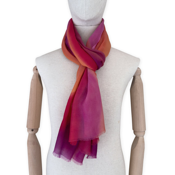Mannequin wearing scarf on a white background. Hand-painted pure cashmere scarf by Otta-Italy, 66 x 200 cm, featuring red, fuchsia and orange. Luxury Italian cashmere accessory, soft and warm scarf for women and men.
