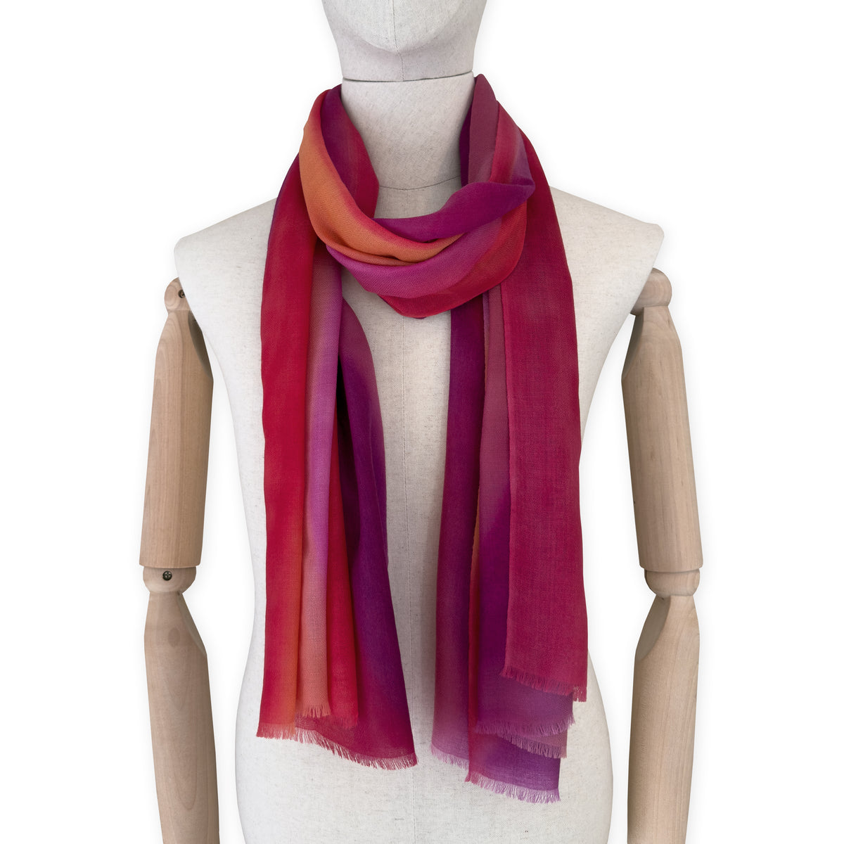 Mannequin wearing scarf on a white background. Hand-painted pure cashmere scarf by Otta-Italy, 66 x 200 cm, featuring red, fuchsia and orange. Luxury Italian cashmere accessory, soft and warm scarf for women and men.
