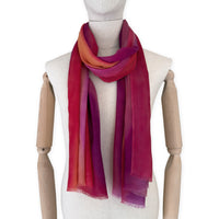 Mannequin wearing scarf on a white background. Hand-painted pure cashmere scarf by Otta-Italy, 66 x 200 cm, featuring red, fuchsia and orange. Luxury Italian cashmere accessory, soft and warm scarf for women and men.

