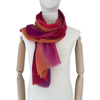 Mannequin wearing scarf on a white background. Hand-painted pure cashmere scarf by Otta-Italy, 66 x 200 cm, featuring red, fuchsia and orange. Luxury Italian cashmere accessory, soft and warm scarf for women and men.
