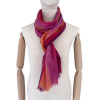 Mannequin wearing scarf on a white background. Hand-painted pure cashmere scarf by Otta-Italy, 66 x 200 cm, featuring red, fuchsia and orange. Luxury Italian cashmere accessory, soft and warm scarf for women and men.
