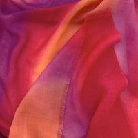 Close-up of soft fabric. Hand-painted pure cashmere scarf by Otta-Italy, 66 x 200 cm, featuring red, fuchsia and orange. Luxury Italian cashmere accessory, soft and warm scarf for women and men.
