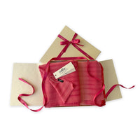 Set of scarves in a gift box with a pink ribbon on a white background. 
Hand-painted cashmere & wool blend scarf by Otta-Italy, 57 x 180 cm, featuring 
red, fuchsia and pink. Luxury Italian cashmere & wool accessory, soft and warm scarf for women and men.
