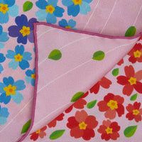 Close-up of an exclusive Otta silk twill scarf showcasing vibrant printed details of Primavera Persiana in Pink with delicate hand-rolled edges.

