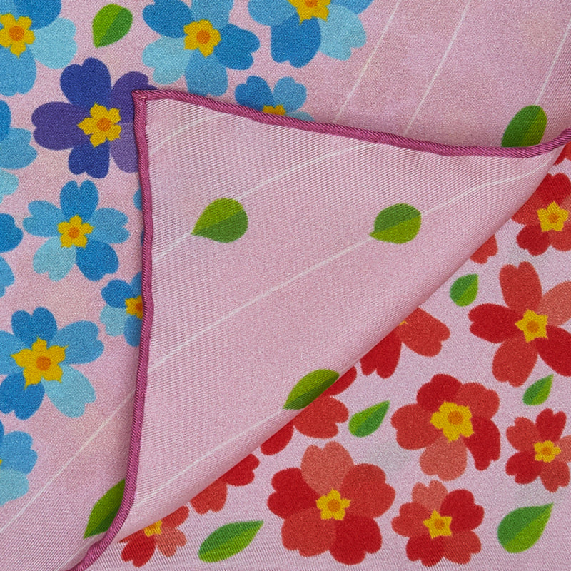 Close-up of an exclusive Otta silk twill scarf showcasing vibrant printed details of Primavera Persiana in Pink with delicate hand-rolled edges.
