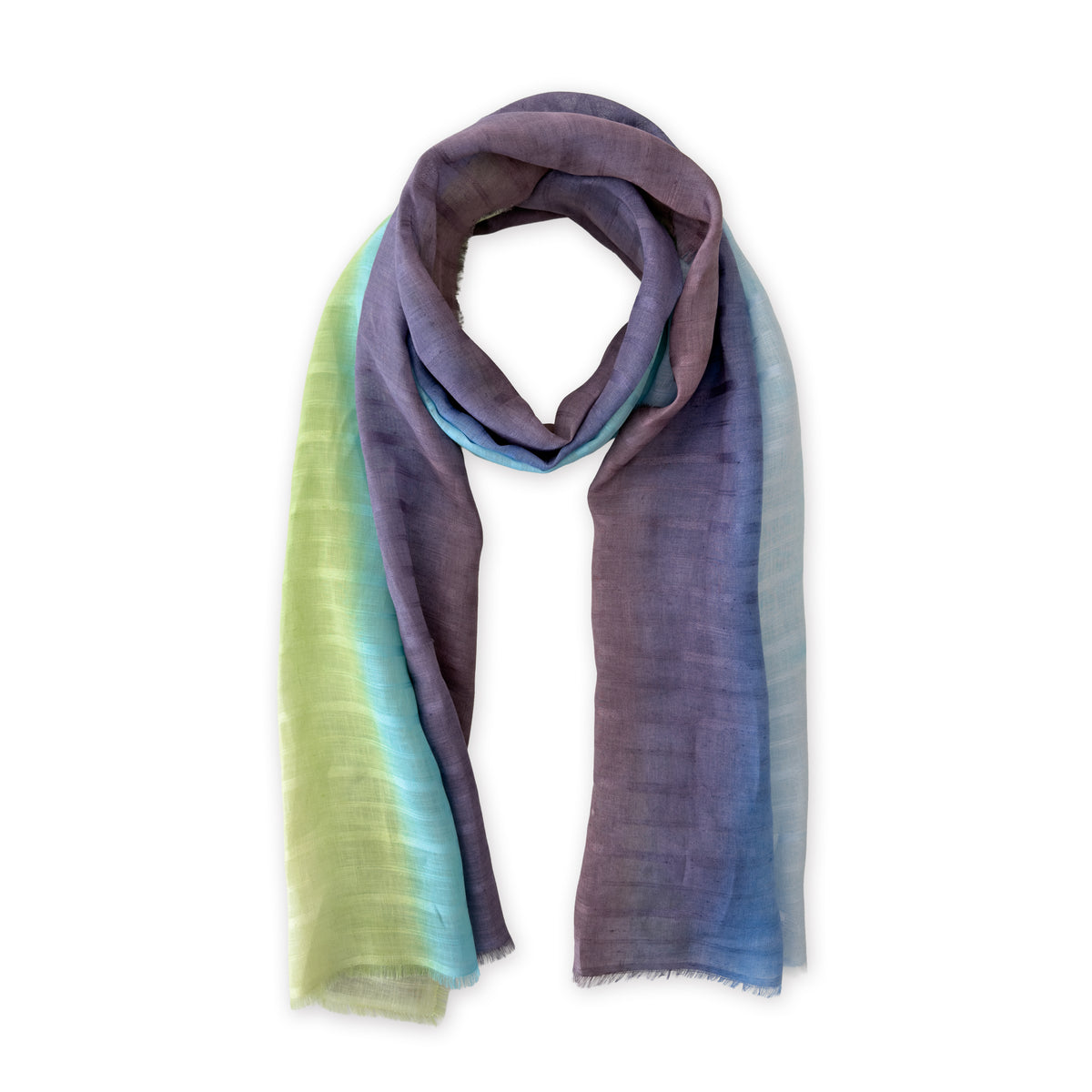 Hand-painted Otta pure linen scarf in 
blue, turquoise, green and purple, loosely looped to showcase its full length and delicate texture in white background. Lightweight artisan accessory with hand-sewn edges, measuring 70 x 190 cm.
