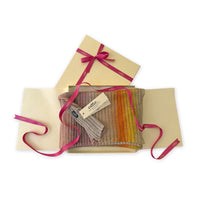 Gift box with a colorful sock set and a visible brand tag on a white background. linen-scarf-hand-painted-28x192cm-brown-pastel pink-orange-yellow-otta-italy
