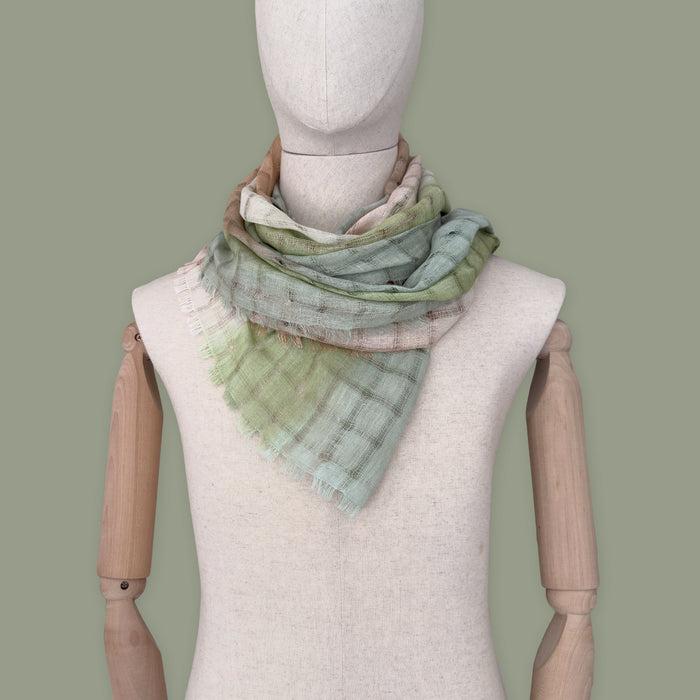 Mannequin wearing scarf on a pastel green background. Hand-painted linen scarf by Otta-Italy, 48 x 190 cm, featuring 
green and beige. Luxury Italian pure linen accessory, soft, fresh and lightweight scarf for women and men.
