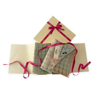 Set of scarves in a gift box with a pink ribbon on a white background. 
Hand-painted linen scarf by Otta-Italy, 48 x 190 cm, featuring 
green and beige. Luxury Italian pure linen accessory, soft, fresh and lightweight scarf for women and men.
