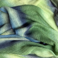 Close-up of fabric. Hand-painted linen scarf by Otta-Italy, 35 x 202 cm, featuring green and blue colors. Luxury Italian linen scarf, soft and lightweight scarf for women and men.
