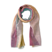 Hand-painted Otta pure linen scarf in 
pink, peach, fuchsia and gray, loosely looped to showcase its full length and delicate texture in white background. Lightweight artisan accessory with hand-sewn edges, measuring 70 x 190 cm.
