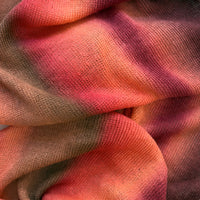 Close-up of fabric. Hand-painted linen scarf by Otta-Italy, 32 x 200 cm, featuring red, coral and brown colors. Luxury Italian linen scarf, soft and lightweight scarf for women and men.

