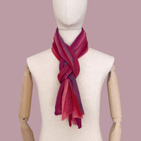 Mannequin wearing scarf on a pastel pink background. Hand-painted linen scarf by Otta-Italy, 33 x 205 cm, featuring 
red and purple. Luxury Italian pure linen accessory, soft, fresh and lightweight scarf for women and men.
