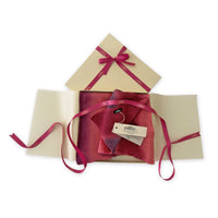 Set of scarves in a gift box with a pink ribbon on a white background. 
Hand-painted linen scarf by Otta-Italy, 33 x 205 cm, featuring 
red and purple. Luxury Italian pure linen accessory, soft, fresh and lightweight scarf for women and men.

