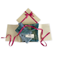 Set of scarves in a gift box with a pink ribbon on a white background. 
Hand-painted linen scarf by Otta-Italy, 52 x 205 cm, featuring 
blue, light blue and green. Luxury Italian pure linen accessory, soft, fresh and lightweight scarf for women and men.
