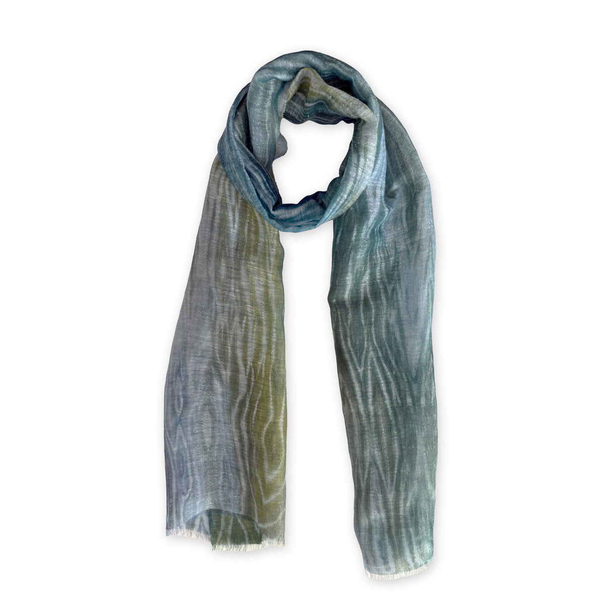 Hand-painted Otta pure linen scarf in 
blue, light blue and green, loosely looped to showcase its full length and delicate texture in white background. Lightweight artisan accessory with hand-sewn edges, measuring 52 x 205 cm.

