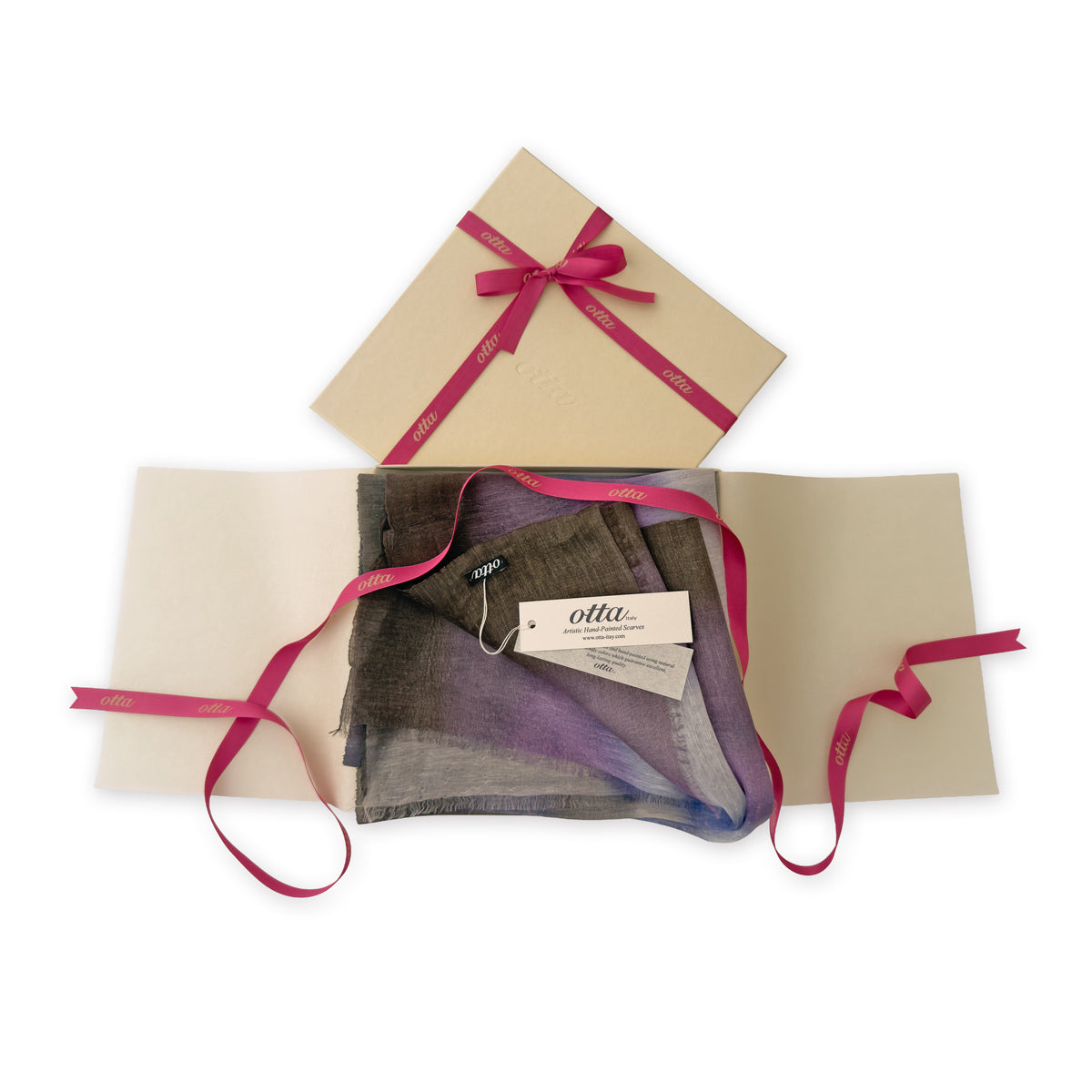 Luxury gift box with a pink ribbon containing a hand-painted Otta linen silk blend scarf on a white background.
