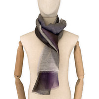 Mannequin wearing an elegant hand-painted Otta linen silk blend scarf on a white background. Indigo, light blue, purple, brown and beige tones.
