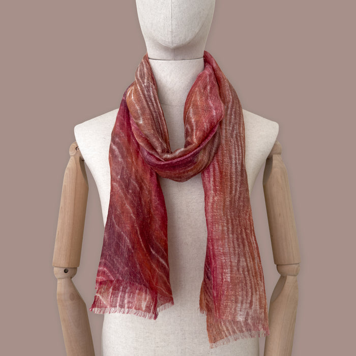 Mannequin wearing scarf on a pastel blue background. Hand-painted linen scarf by Otta-Italy, 203 x 50 cm, featuring 
brown and red. Luxury Italian pure linen accessory, soft, fresh and lightweight scarf for women and men.
