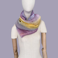 Mannequin wearing scarf on a pastel gray background. Hand-painted linen scarf by Otta-Italy, 52 x 200 cm, featuring 
yellow, purple and lilac. Luxury Italian pure linen accessory, soft, fresh and lightweight scarf for women and men.
