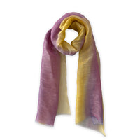 Hand-painted Otta pure linen scarf in 
yellow, purple and lilac, loosely looped to showcase its full length and delicate texture in white background. Lightweight artisan accessory with hand-sewn edges, measuring 52 x 200 cm.
