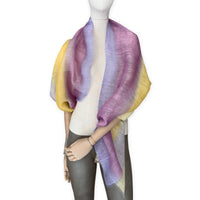 Mannequin wearing a hand-painted Otta pure linen scarf on a white background in 
yellow, purple and lilac tones. soft, fresh and lightweight, and elegant accessory measuring 52 x 200 cm. Unique artisan scarf with hand-sewn edges, perfect for women and men.
