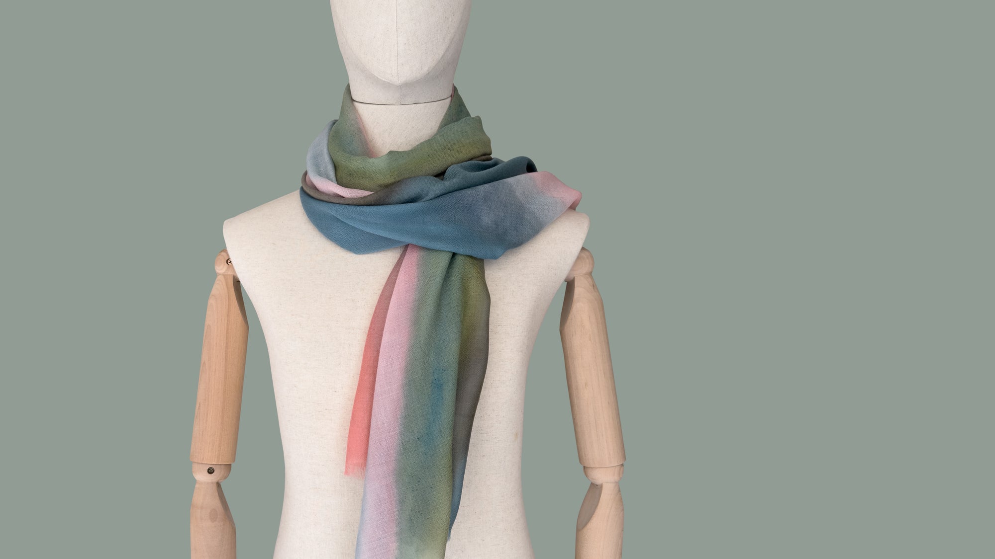 Mannequin wearing a colorful scarf on a plain background
