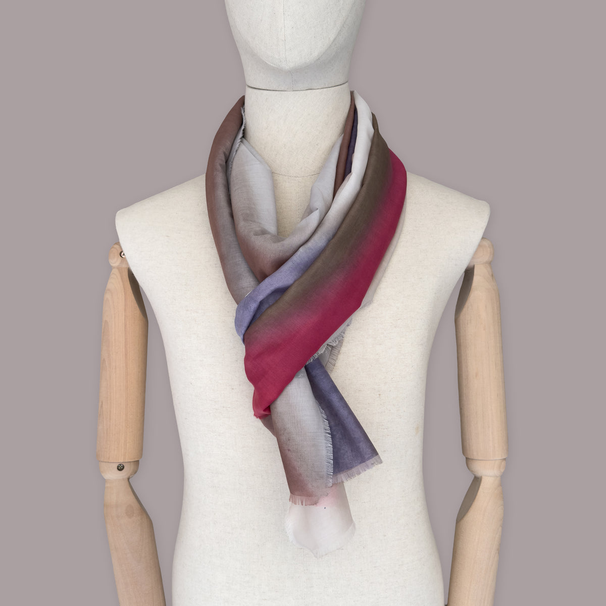 Mannequin wearing scarf on a gray background. Hand-painted silk cotton scarf by Otta-Italy, measuring 70 x 190 cm, featuring 
brown, beige, red and purple shades. Luxury Italian pure silk cotton blend accessory, soft, fresh and lightweight scarf for women and men.
